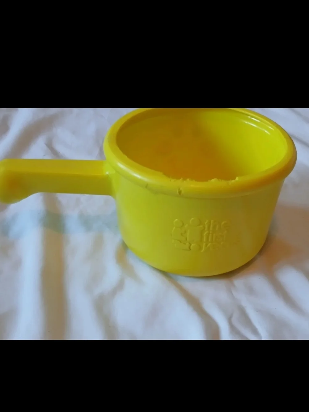The First Years Yellow Smiley Toy Cooking Pot with Handle for Ages 12-18 Months